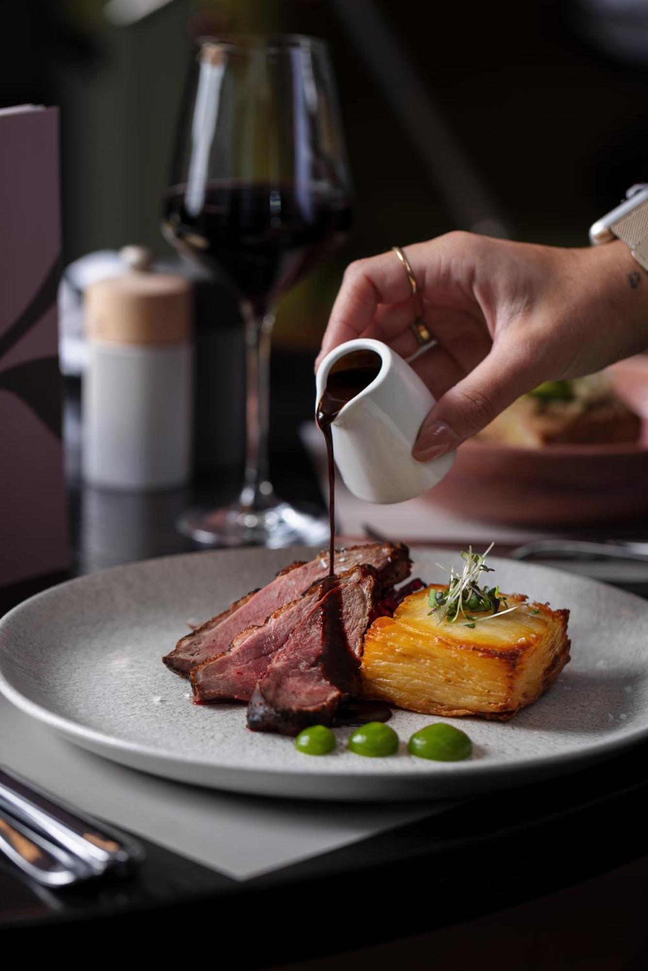 The Morrison Dublin, Curio Collection By Hilton Otel Dış mekan fotoğraf A steak being drizzled with a sauce